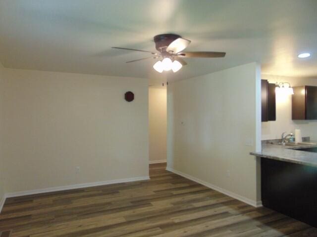 1723 Bermuda Dr, Lima, OH 45801 - kitchen with ceiling fan, wood finished floors, light countertops, baseboards, and dark brown cabinets