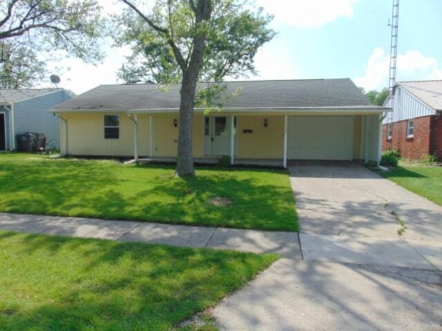 1723 Bermuda Dr, Lima, OH 45801 - ranch-style house featuring driveway, a front lawn, an attached carport, and a garage
