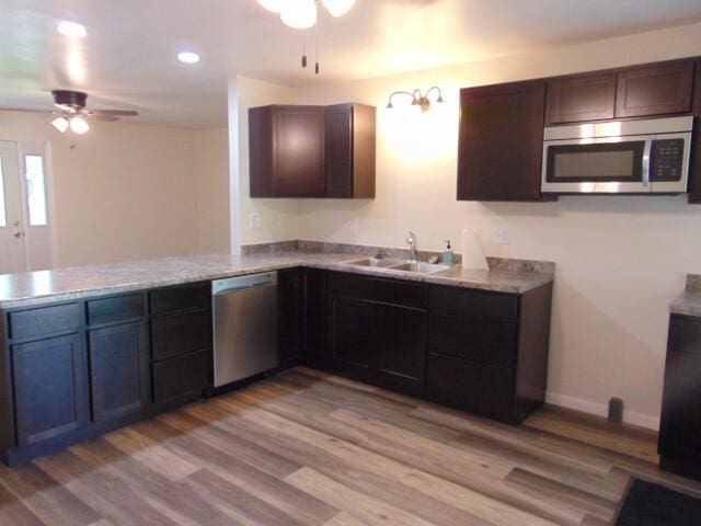 1723 Bermuda Dr, Lima, OH 45801 - kitchen featuring stainless steel appliances, ceiling fan, a sink, a peninsula, and light wood finished floors