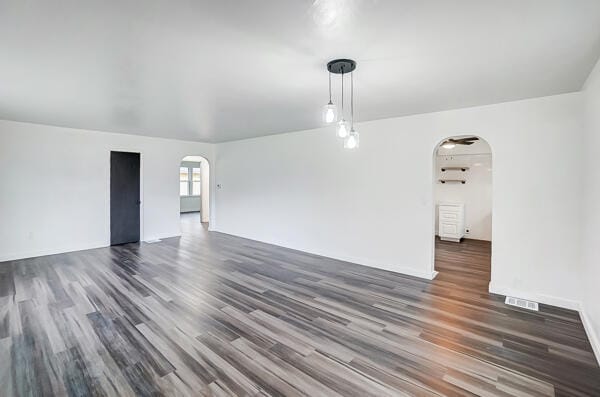 empty room with dark hardwood / wood-style flooring