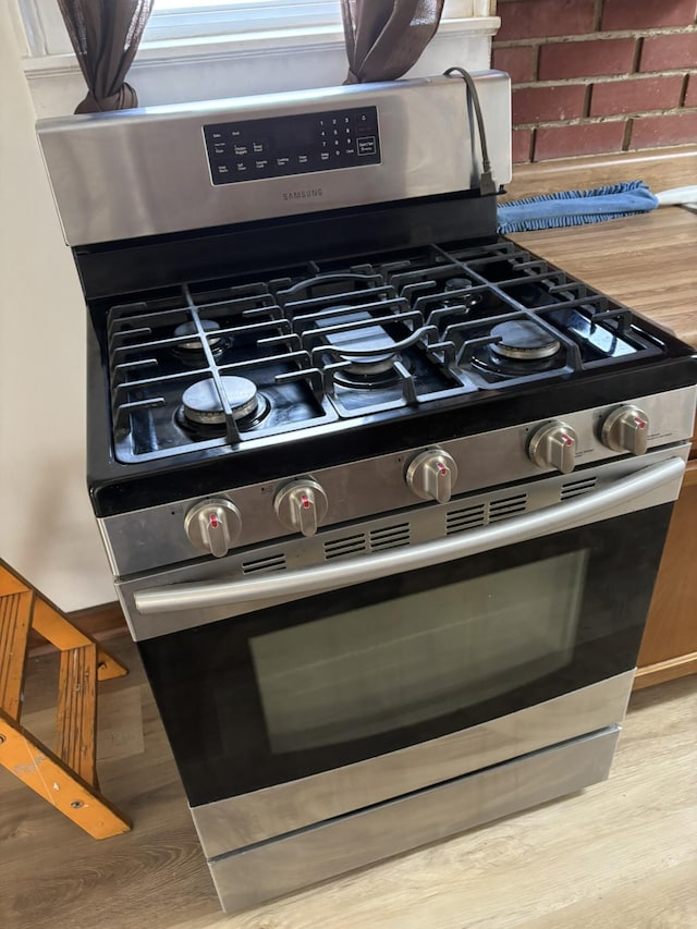 320 N Clairmont Ave, Springfield, OH 45503 - kitchen view of stainless steel gas stove and wood finished floors