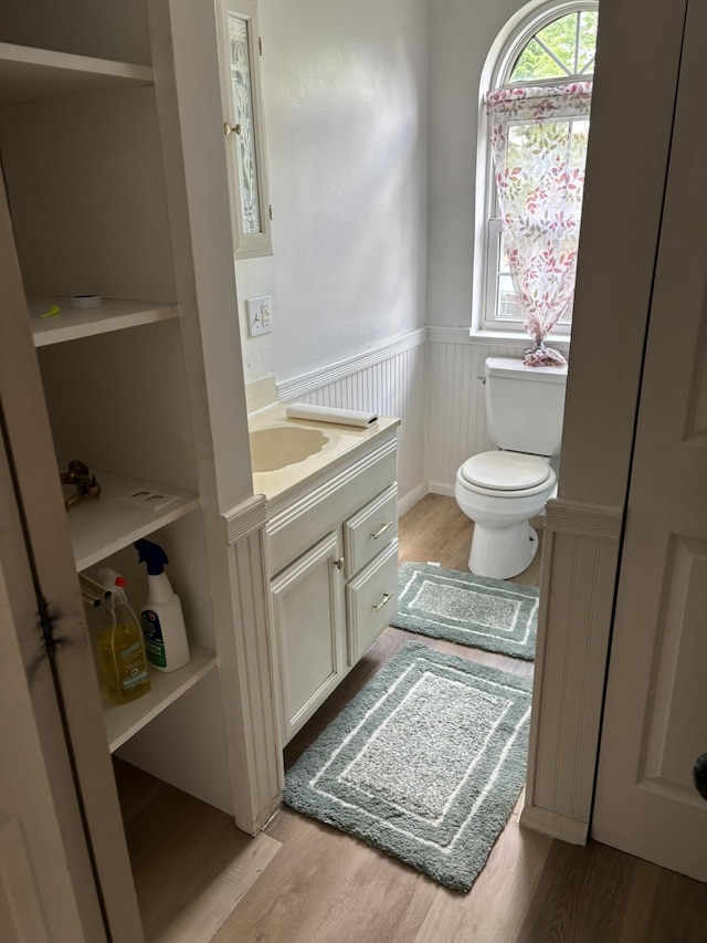 320 N Clairmont Ave, Springfield, OH 45503 - half bath with a wainscoted wall, vanity, and wood finished floors