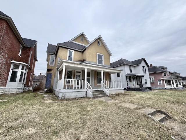 view of front of home with a front yard and covered porch