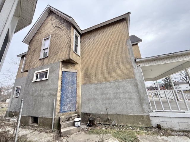 back of property featuring a porch