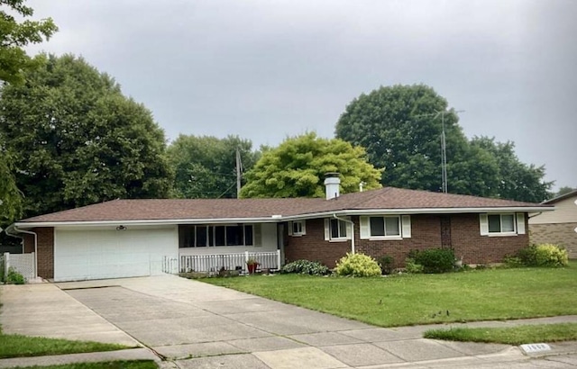 1008 Imperial Blvd, Springfield, OH 45503 - ranch-style home featuring a porch, a garage, a front yard, driveway, and brick siding