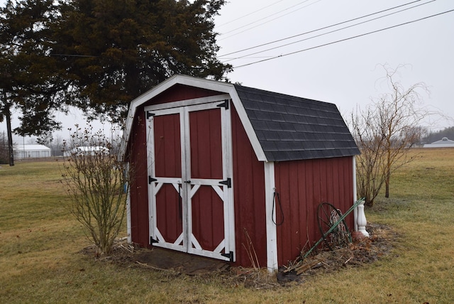 view of outbuilding featuring a yard