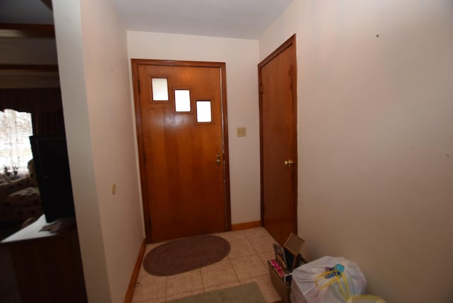 doorway to outside featuring light tile patterned floors