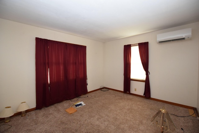 carpeted spare room featuring an AC wall unit