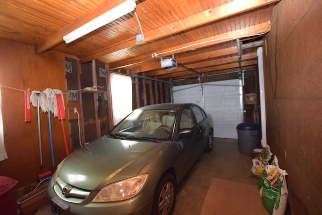 garage featuring a garage door opener and a carport