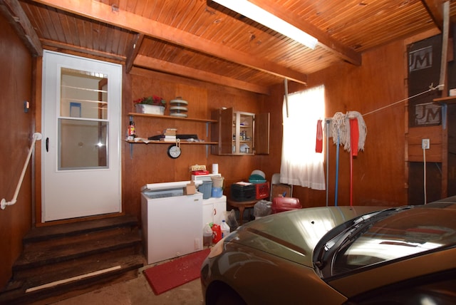 interior space with fridge, wooden ceiling, wood walls, and washer / clothes dryer