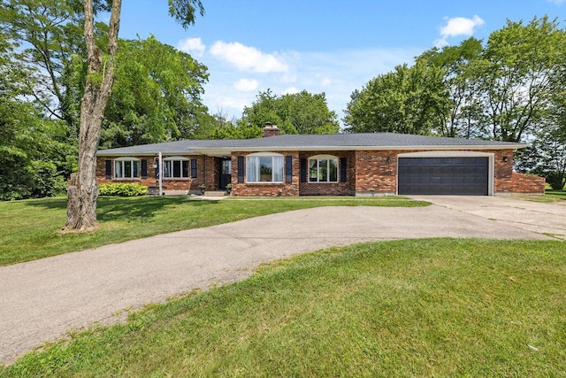 930 N Bickett Rd, Xenia, OH 45385 - ranch-style house with concrete driveway, brick siding, a garage, and a front lawn