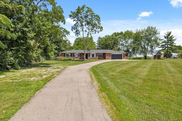 930 N Bickett Rd, Xenia, OH 45385 - ranch-style home featuring a garage, driveway, brick siding, and a front yard