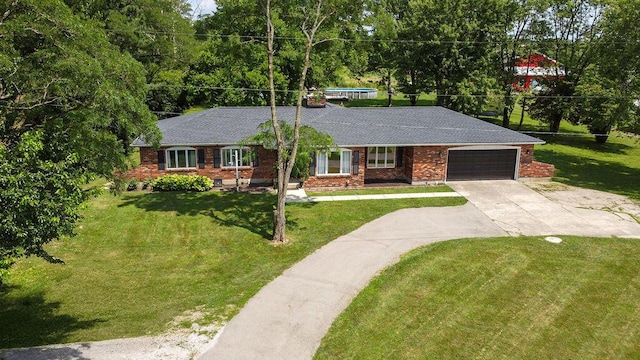 930 N Bickett Rd, Xenia, OH 45385 - single story home with a garage, driveway, a front lawn, and brick siding