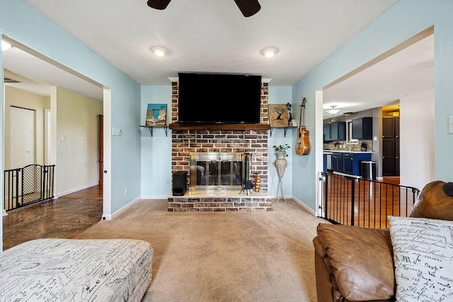 930 N Bickett Rd, Xenia, OH 45385 - living room featuring a ceiling fan, carpet floors, and a brick fireplace