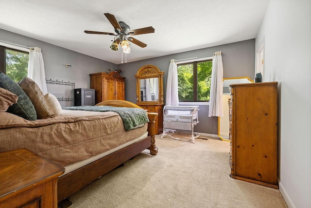 930 N Bickett Rd, Xenia, OH 45385 - bedroom featuring multiple windows, light colored carpet, and a ceiling fan