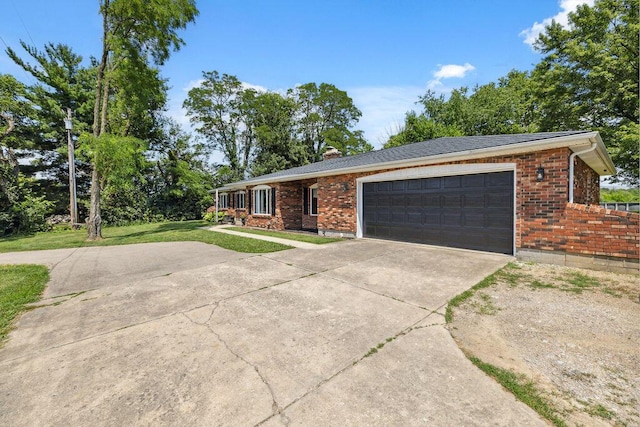 930 N Bickett Rd, Xenia, OH 45385 - single story home featuring driveway, brick siding, an attached garage, a front lawn, and a chimney