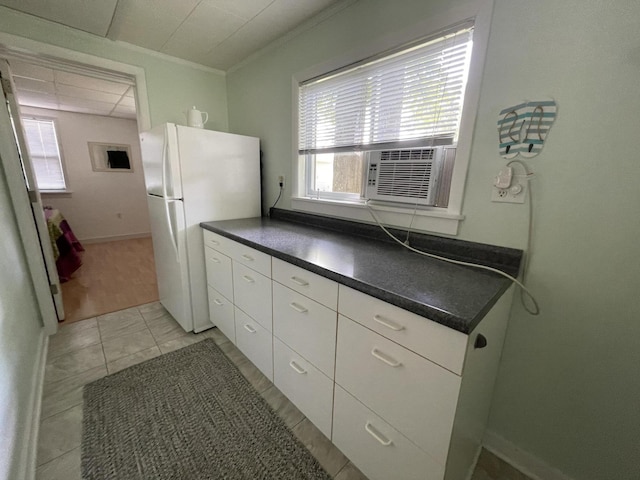 kitchen featuring crown molding, white fridge, white cabinets, cooling unit, and a drop ceiling