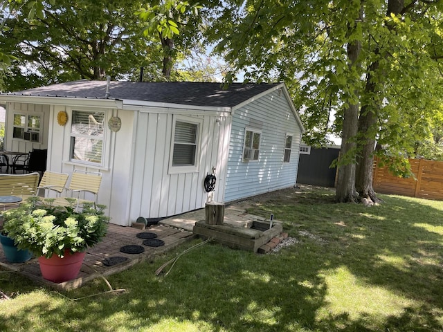 view of outbuilding with a lawn