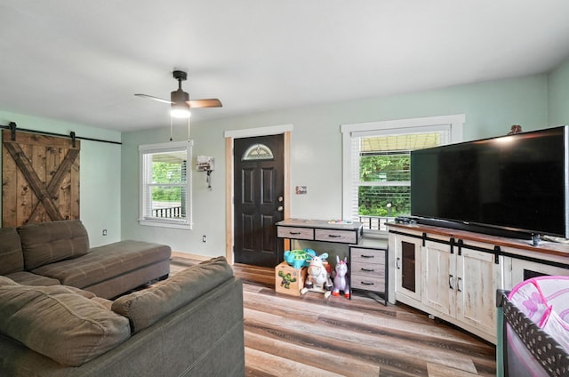 5638 Old Rte 70, Springfield, OH 45502 - living room featuring a barn door, a ceiling fan, and wood finished floors