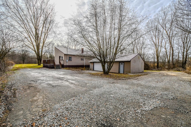 exterior space with a garage and a deck