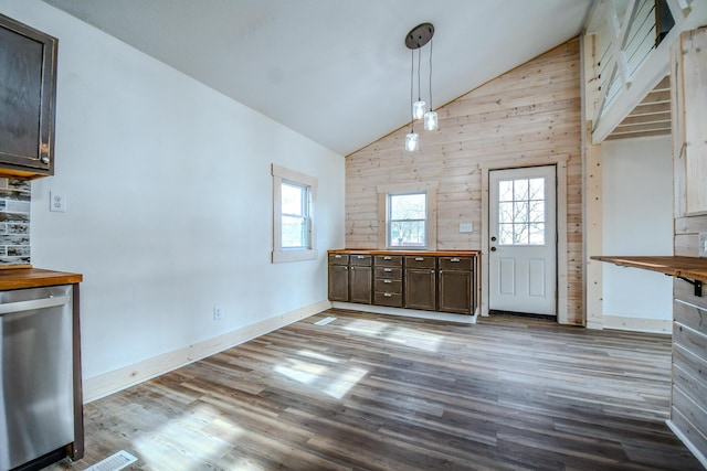 interior space with light hardwood / wood-style flooring, stainless steel dishwasher, dark brown cabinetry, and decorative light fixtures