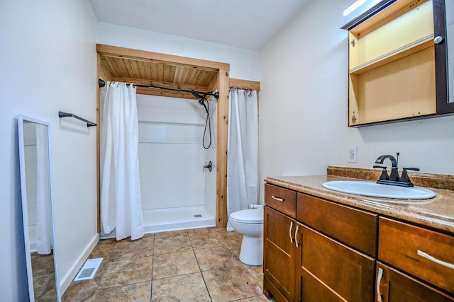 bathroom featuring a shower with curtain, vanity, toilet, and tile patterned flooring