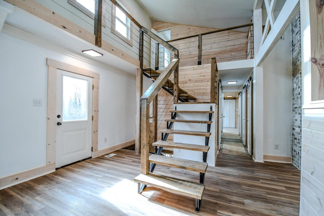 foyer entrance featuring a high ceiling and hardwood / wood-style flooring