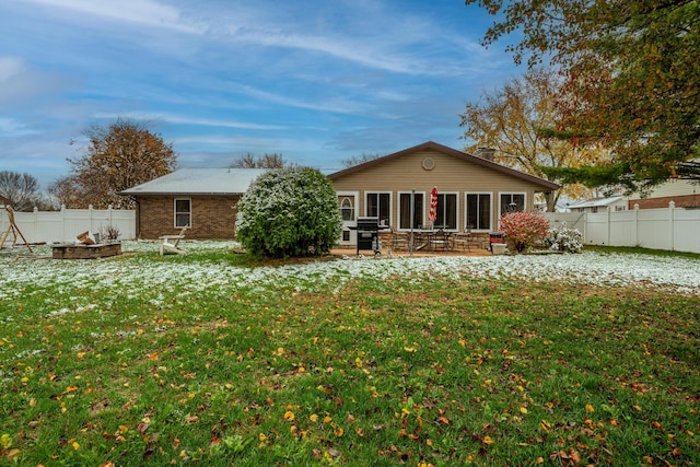 back of property featuring a yard