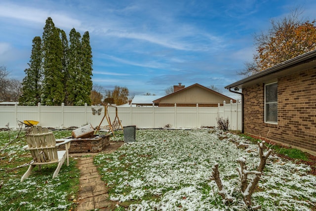 view of yard layered in snow