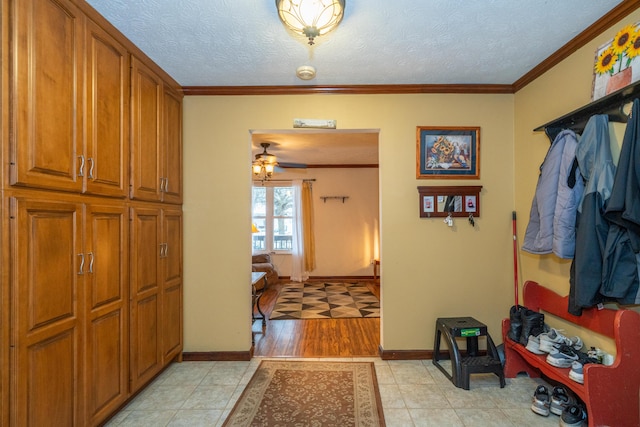 interior space with ornamental molding and a textured ceiling