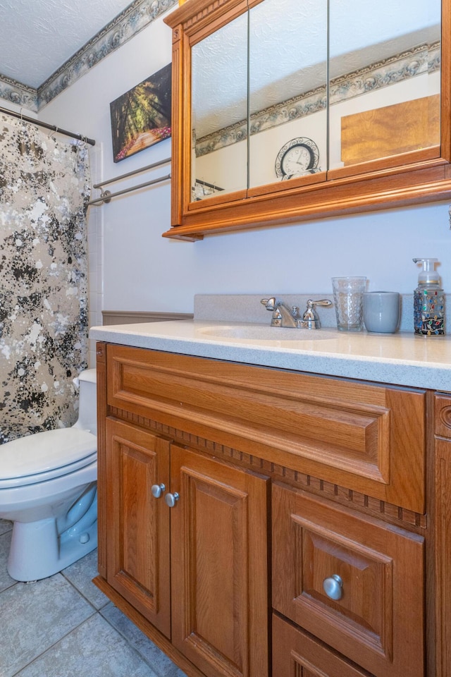 bathroom with vanity, toilet, tile patterned flooring, and a shower with shower curtain