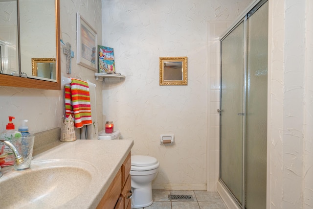 bathroom featuring vanity, a shower with shower door, tile patterned floors, and toilet