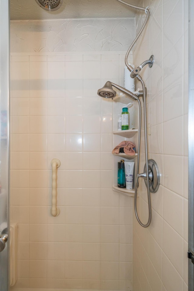 bathroom with tiled shower