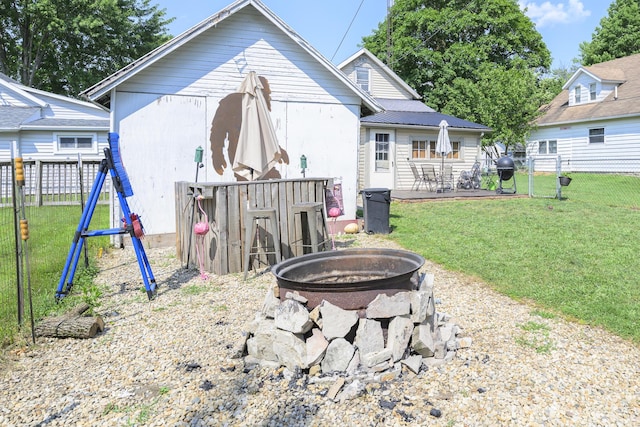 208 E Main St, Belle Center, OH 43310 - back of property with an outdoor fire pit, a fenced backyard, a playground, and a metal roof