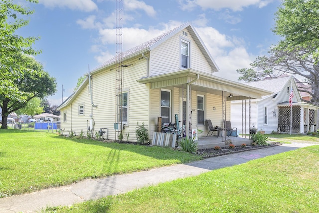 208 E Main St, Belle Center, OH 43310 - view of front of home with covered porch and a front lawn