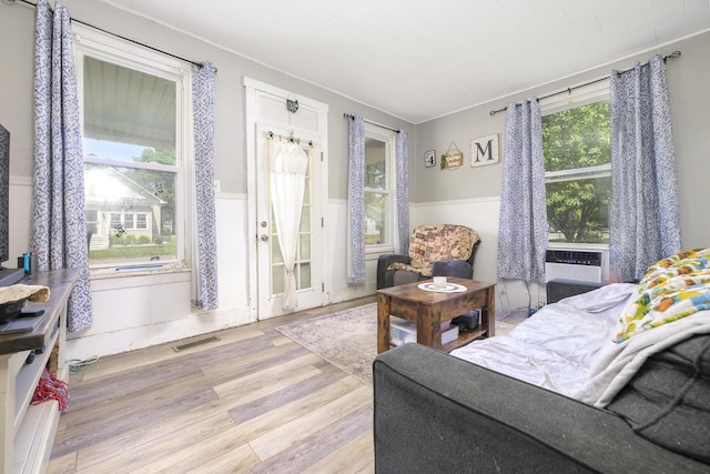 208 E Main St, Belle Center, OH 43310 - bedroom featuring wainscoting, wood finished floors, cooling unit, and ornamental molding