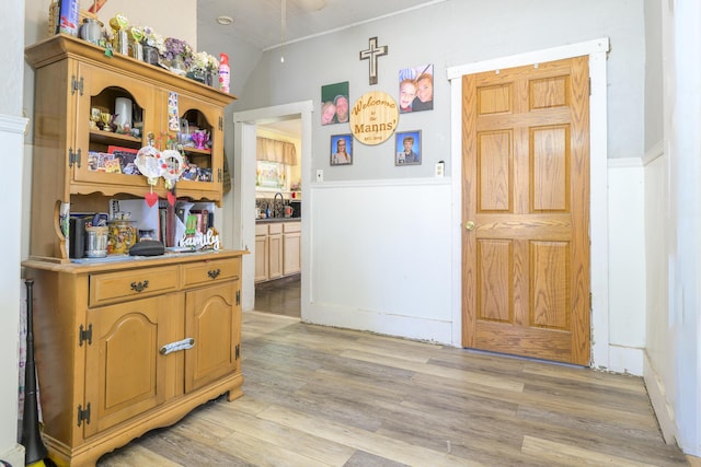 208 E Main St, Belle Center, OH 43310 - hallway with a wainscoted wall and light wood-type flooring