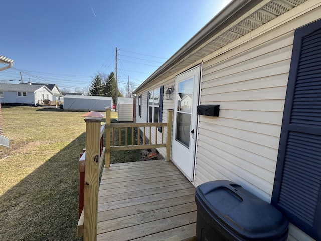 wooden deck featuring a lawn