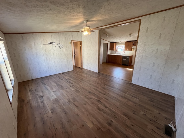 unfurnished living room featuring ceiling fan, visible vents, a textured ceiling, and dark wood-style floors