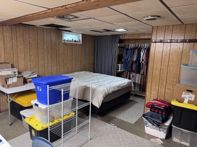 607 W S St, Saint Marys, OH 45885 - bedroom with wood walls, a drop ceiling, a closet, and concrete flooring