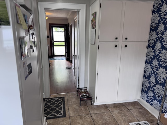 607 W S St, Saint Marys, OH 45885 - hall with wallpapered walls, baseboards, and dark tile patterned flooring