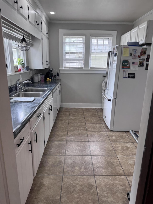 607 W S St, Saint Marys, OH 45885 - kitchen featuring white appliances, a sink, ornamental molding, dark countertops, and healthy amount of natural light