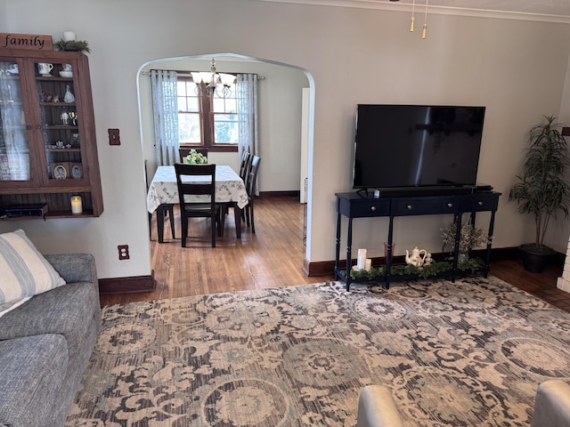 607 W S St, Saint Marys, OH 45885 - living room featuring arched walkways, a chandelier, wood finished floors, and baseboards