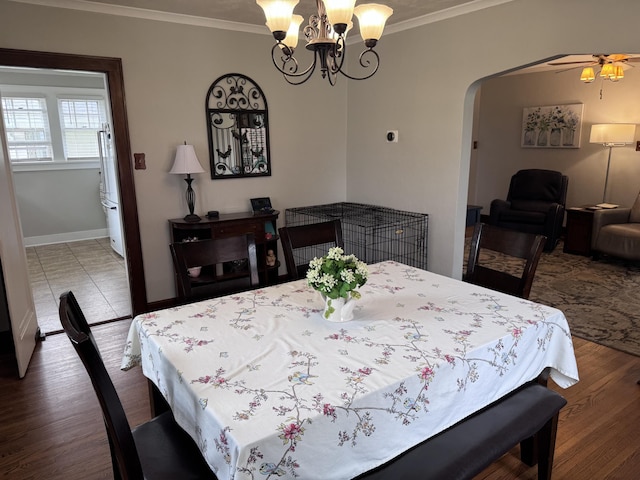 607 W S St, Saint Marys, OH 45885 - dining space with crown molding, a chandelier, arched walkways, baseboards, and wood finished floors