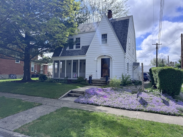 607 W S St, Saint Marys, OH 45885 - view of front facade featuring roof with shingles, a front lawn, a chimney, and covered porch