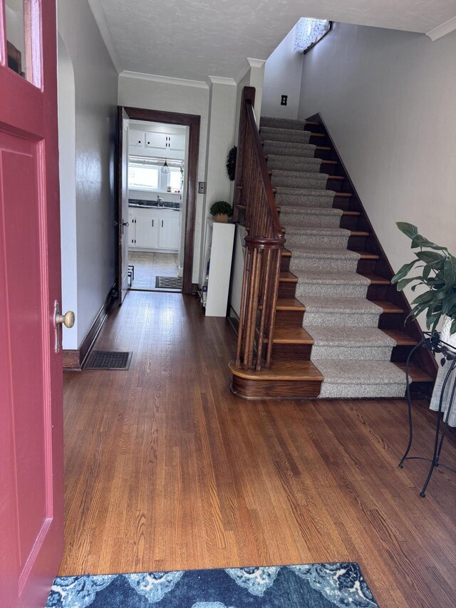 607 W S St, Saint Marys, OH 45885 - foyer entrance with stairs, wood finished floors, and ornamental molding
