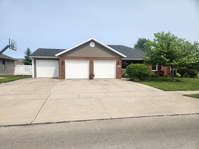1206 Kimberly Dr, Saint Marys, OH 45885 - view of front of house featuring an attached garage, driveway, and brick siding