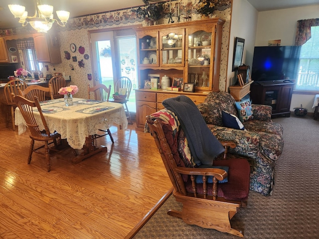 1206 Kimberly Dr, Saint Marys, OH 45885 - dining space with wallpapered walls, a chandelier, healthy amount of natural light, and light wood-style floors