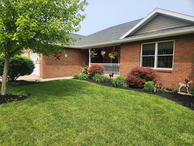 1206 Kimberly Dr, Saint Marys, OH 45885 - ranch-style house with a front lawn, brick siding, roof with shingles, and a porch
