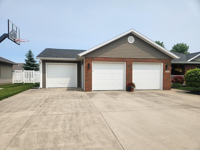 1206 Kimberly Dr, Saint Marys, OH 45885 - view of front of house featuring brick siding, driveway, and a garage